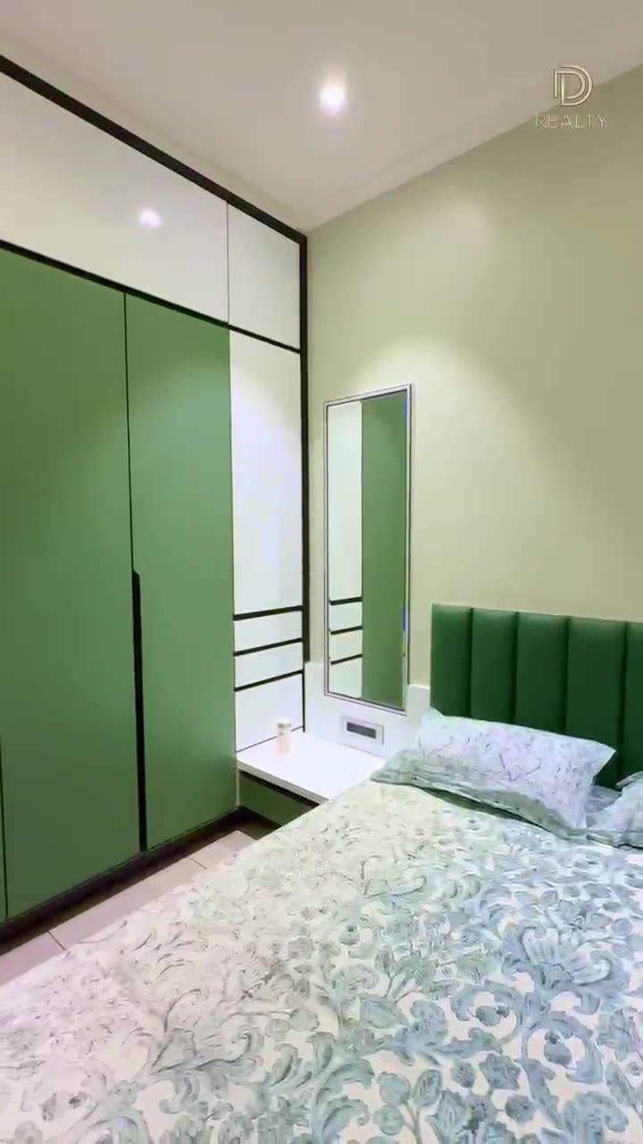 Bedroom with built-in wardrobes in a handed-over D Realty apartment.