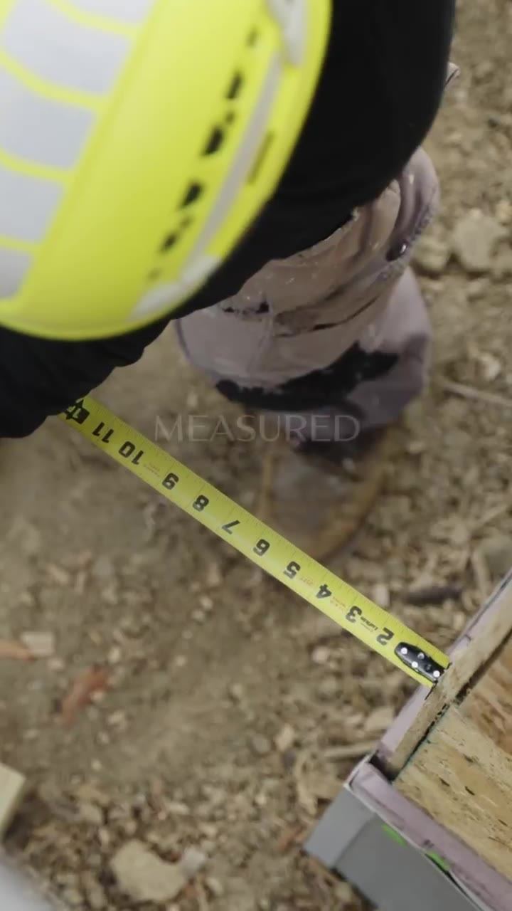 A dimension being measured on site during construction at a D Realty development.