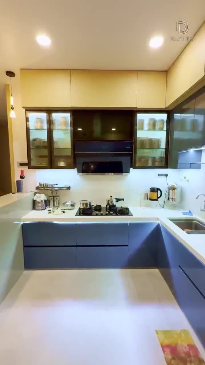 Modular kitchen with full-height storage in a handed-over D Realty apartment.